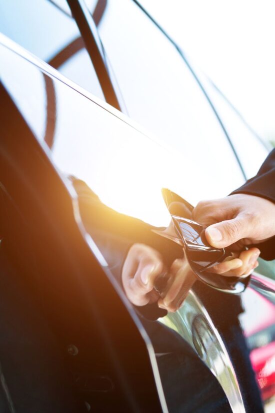 Chauffeur opening luxury car door